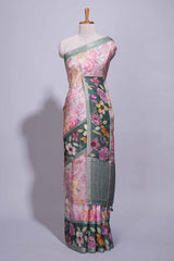 Soft pink linen saree with floral print highlighted with a contrast floral pallu and metallic zari border along with contrast blouse piece