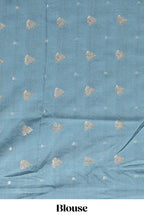 Soft pink linen saree with floral print highlighted with a contrast floral pallu and metallic zari border along with contrast blouse piece