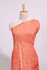 Orange round motifs linen saree with self zari border and contrast checked blouse