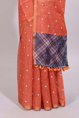 Orange round motifs linen saree with self zari border and contrast checked blouse