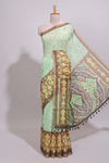 Green geometric ikkat design linen cotton saree with contrast zari border and printed blouse