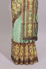 Green geometric ikkat design linen cotton saree with contrast zari border and printed blouse