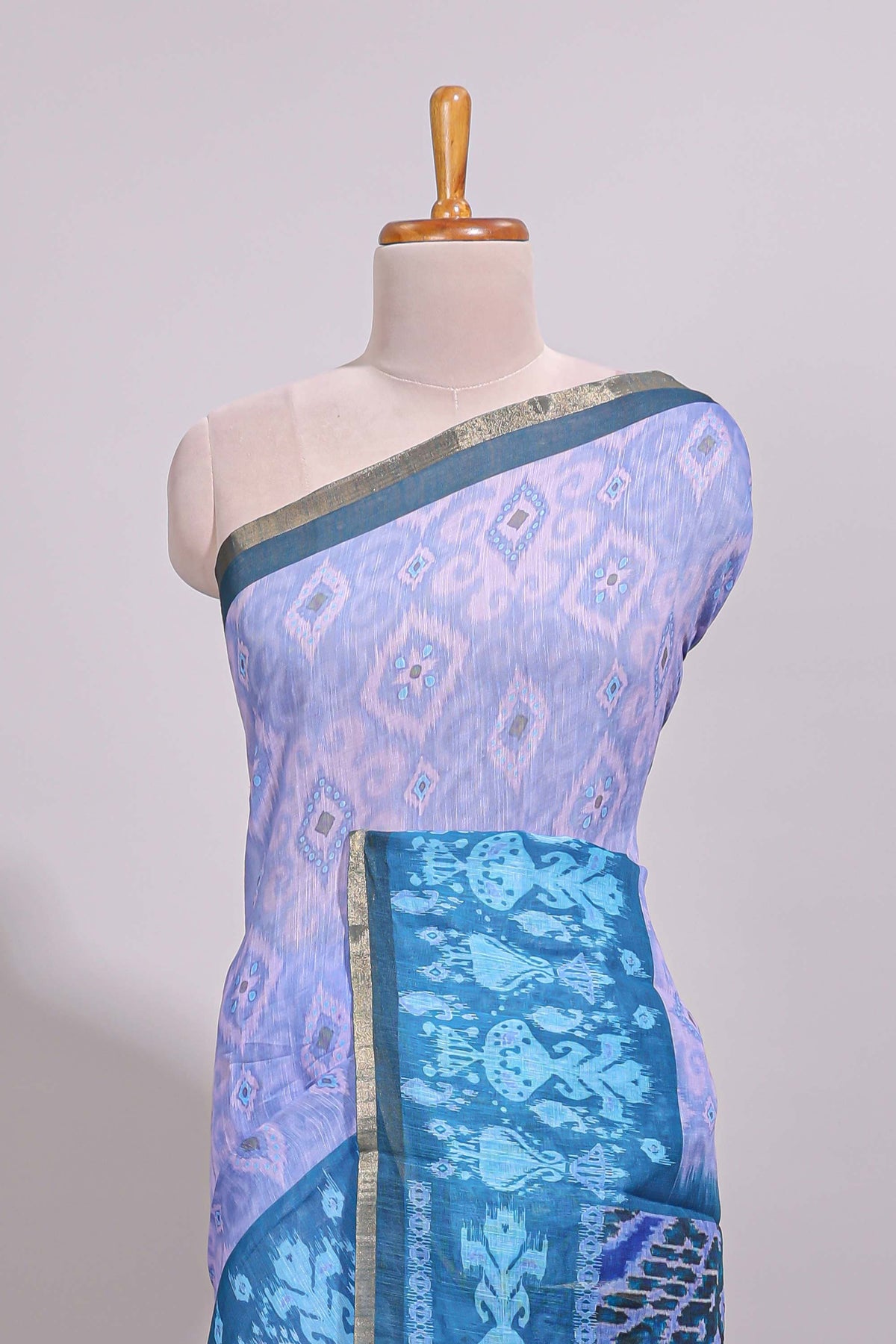 Blue geometric ikkat design linen cotton saree with contrast zari border and printed blouse