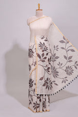 Cream floral design linen cotton saree with self zari border and contrast printed blouse