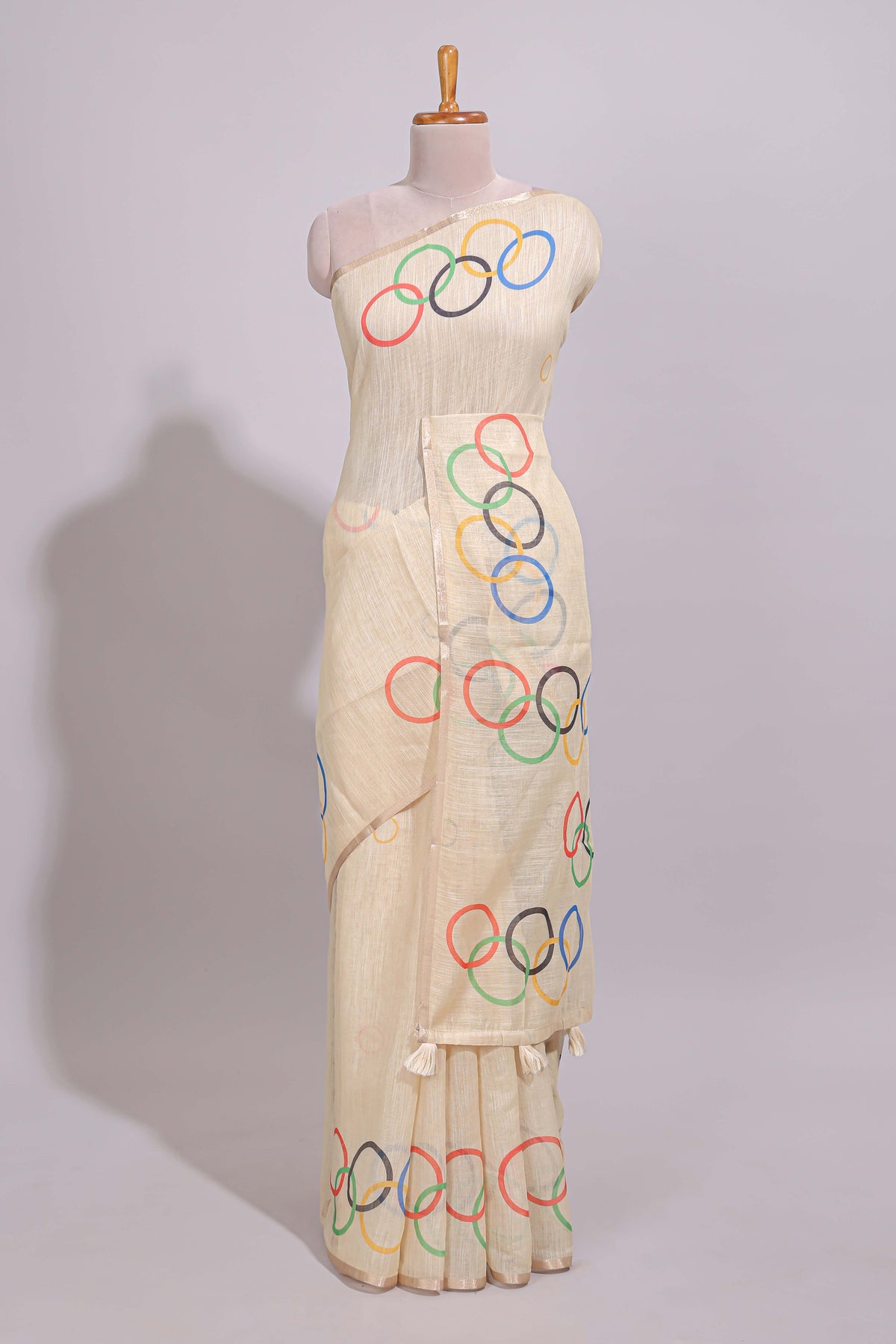 Cream olympic logo design linen cotton saree with self zari border and matching printed blouse