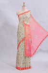 Beige tribal design warli print linen cotton saree with contrast pink zari border and floral design pallu