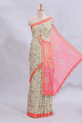 Beige tribal design warli print linen cotton saree with contrast pink zari border and floral design pallu