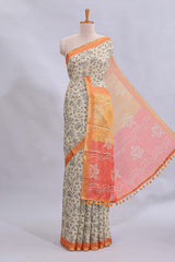 Beige tribal design warli print linen cotton saree with contrast orange zari border and floral design pallu