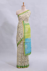 Beige tribal design warli print linen cotton saree with contrast green zari border and floral design pallu