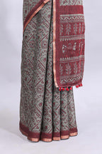 Grey warli tribe design linen cotton saree with contrast zari border and printed blouse