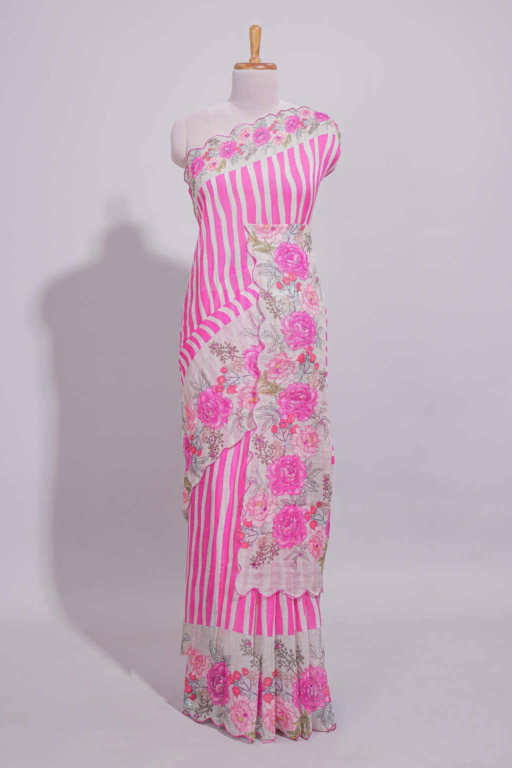 White Linen saree with pink stripes and vibrant pink floral scallop border with contrast printed blouse