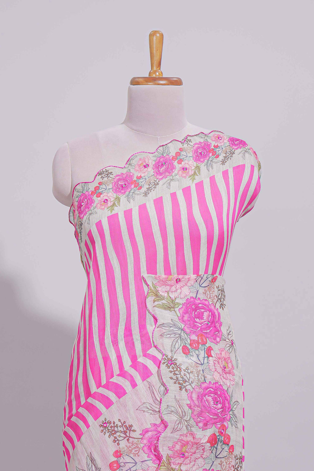 White Linen saree with pink stripes and vibrant pink floral scallop border with contrast printed blouse