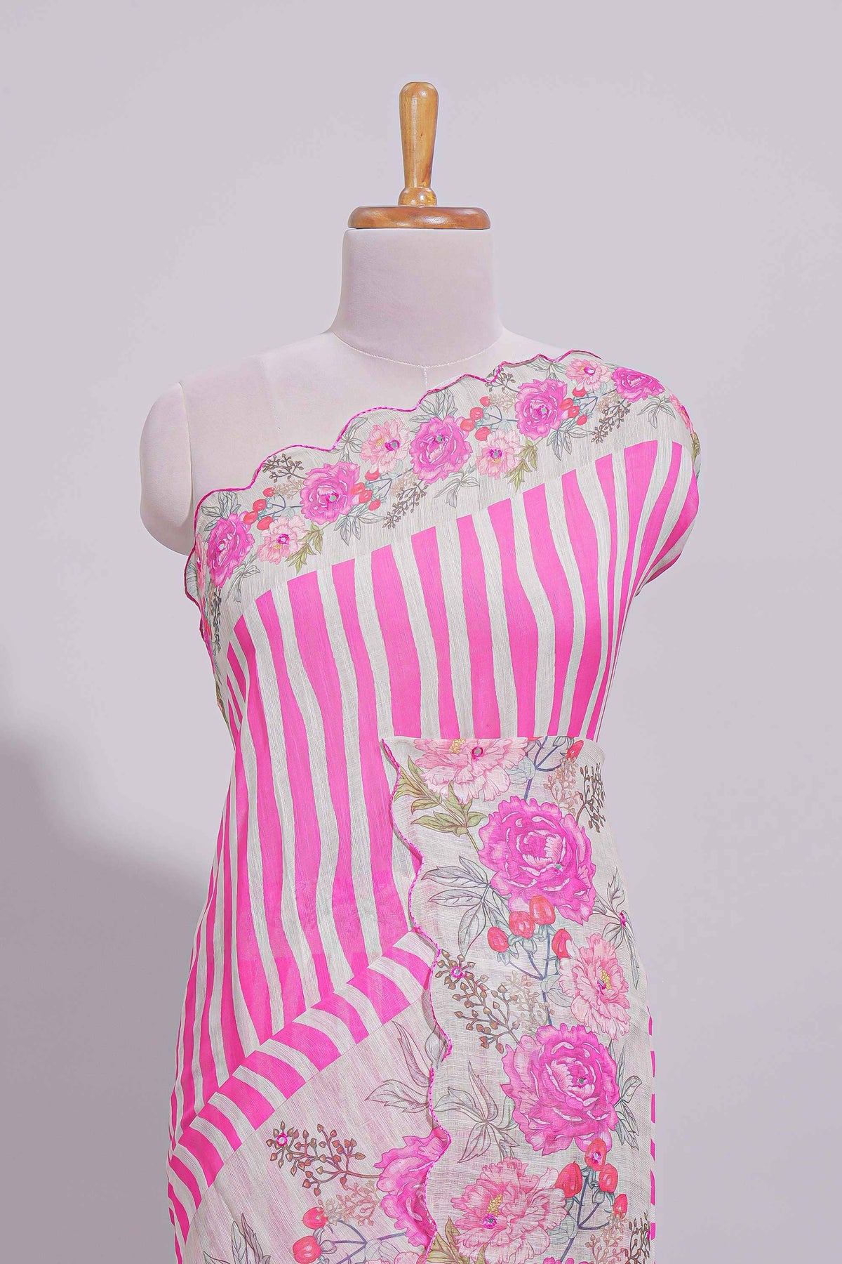 White Linen saree with pink stripes and vibrant pink floral scallop border with contrast printed blouse