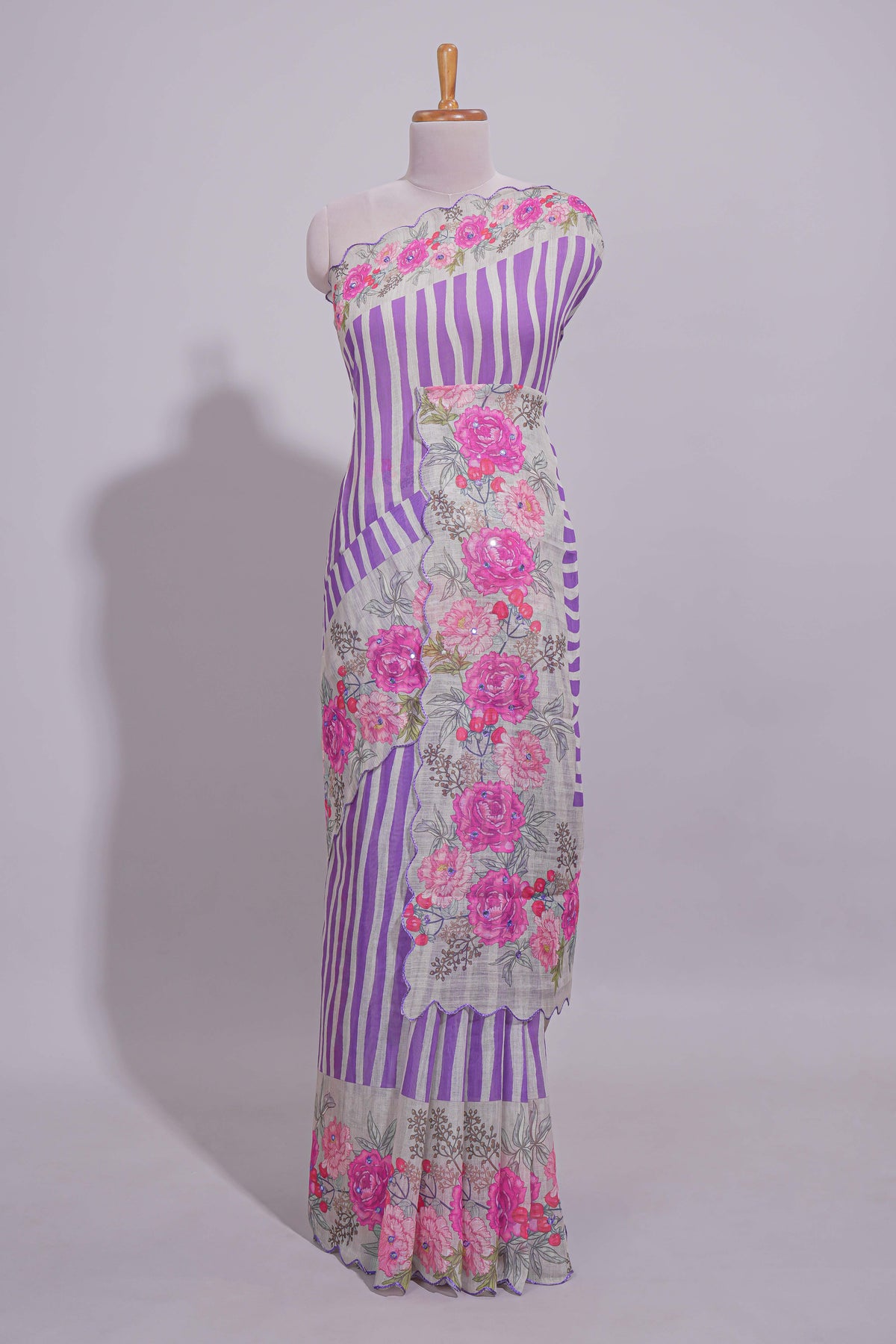 White Linen saree with violet stripes and vibrant pink floral scallop border with contrast printed blouse