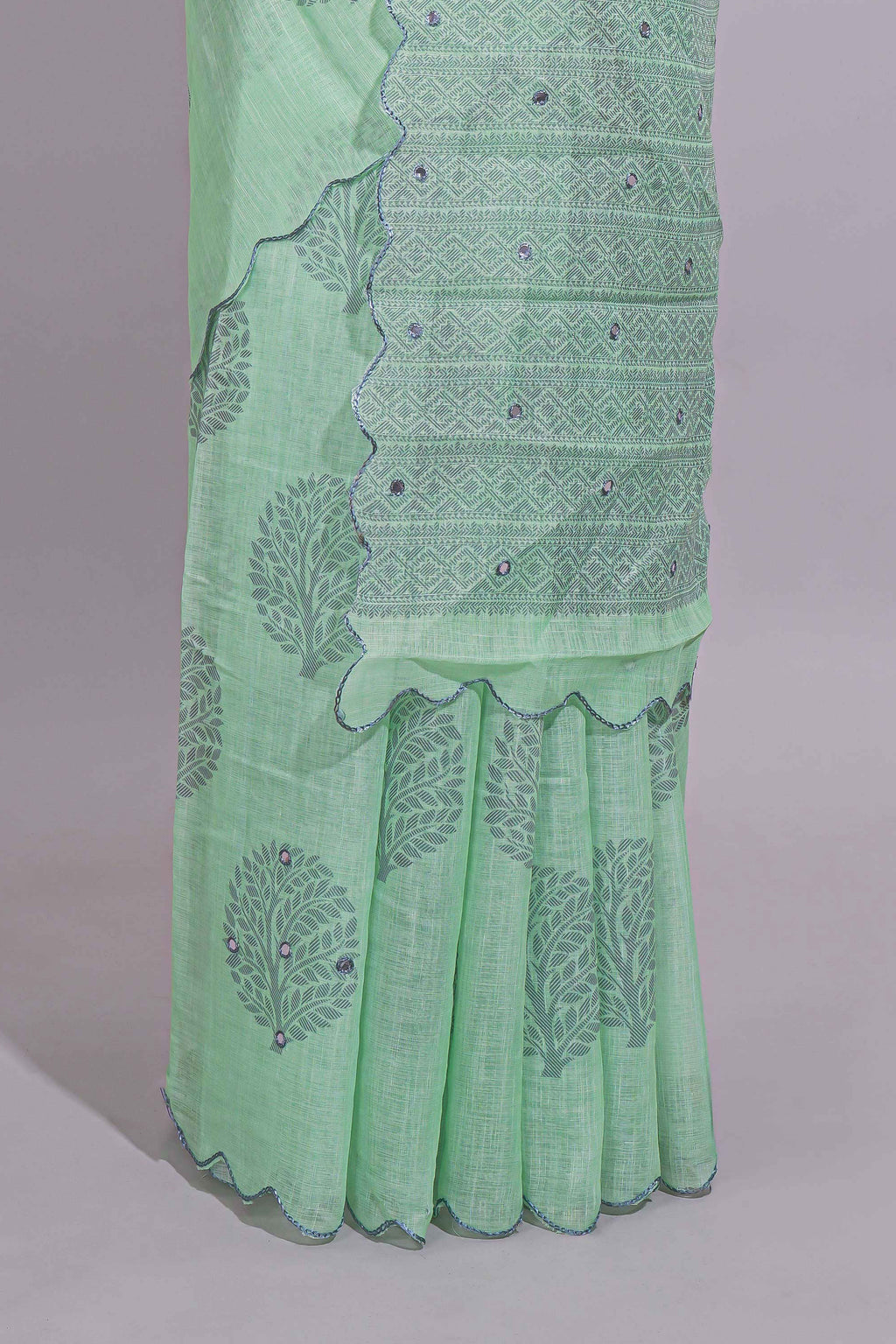 Pastel green linen saree tree motifs and tiny sequin with scalloped border and matching blouse