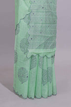 Pastel green linen saree tree motifs and tiny sequin with scalloped border and matching blouse