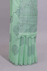 Pastel green linen saree tree motifs and tiny sequin with scalloped border and matching blouse