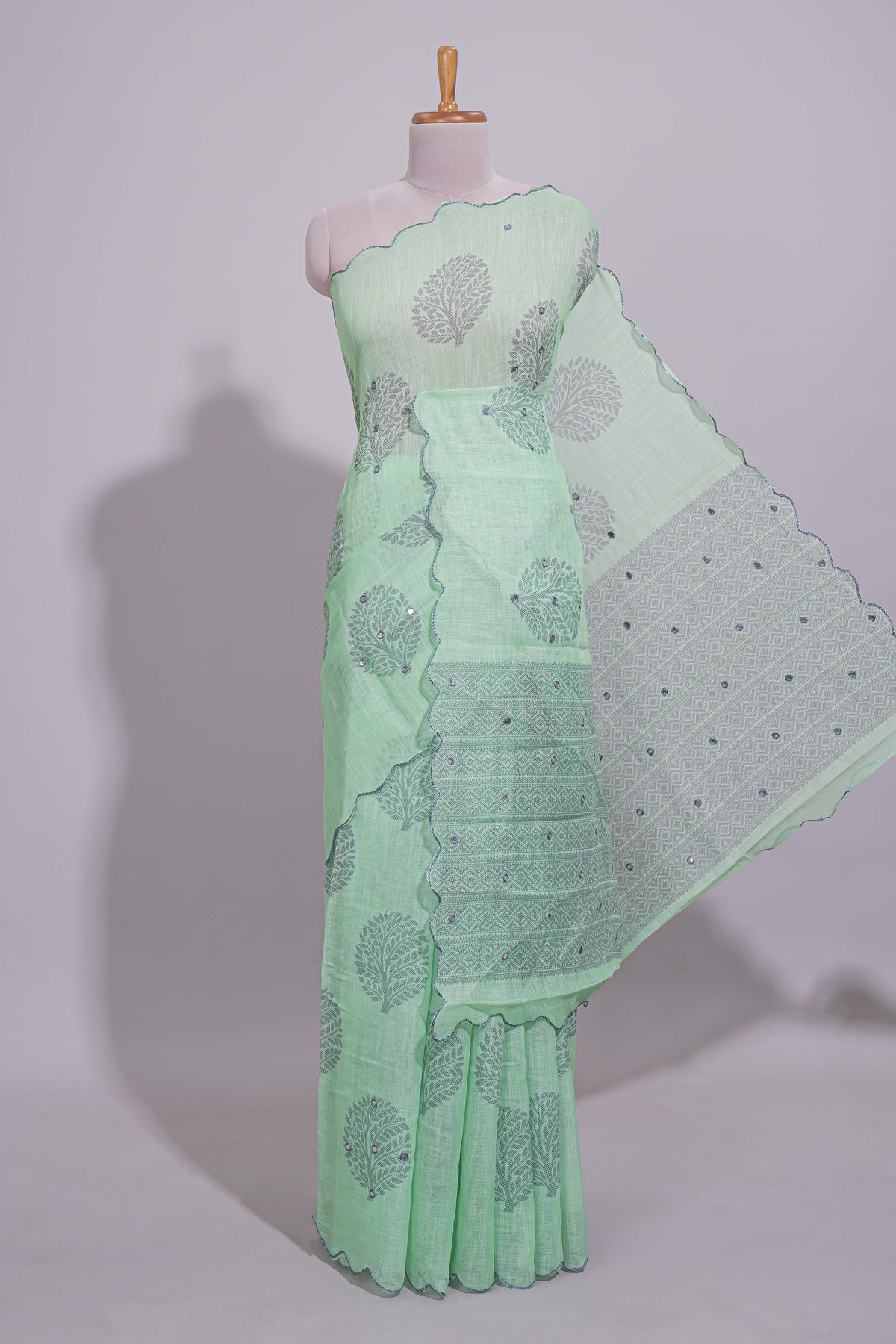 Pastel green linen saree tree motifs and tiny sequin with scalloped border and matching blouse