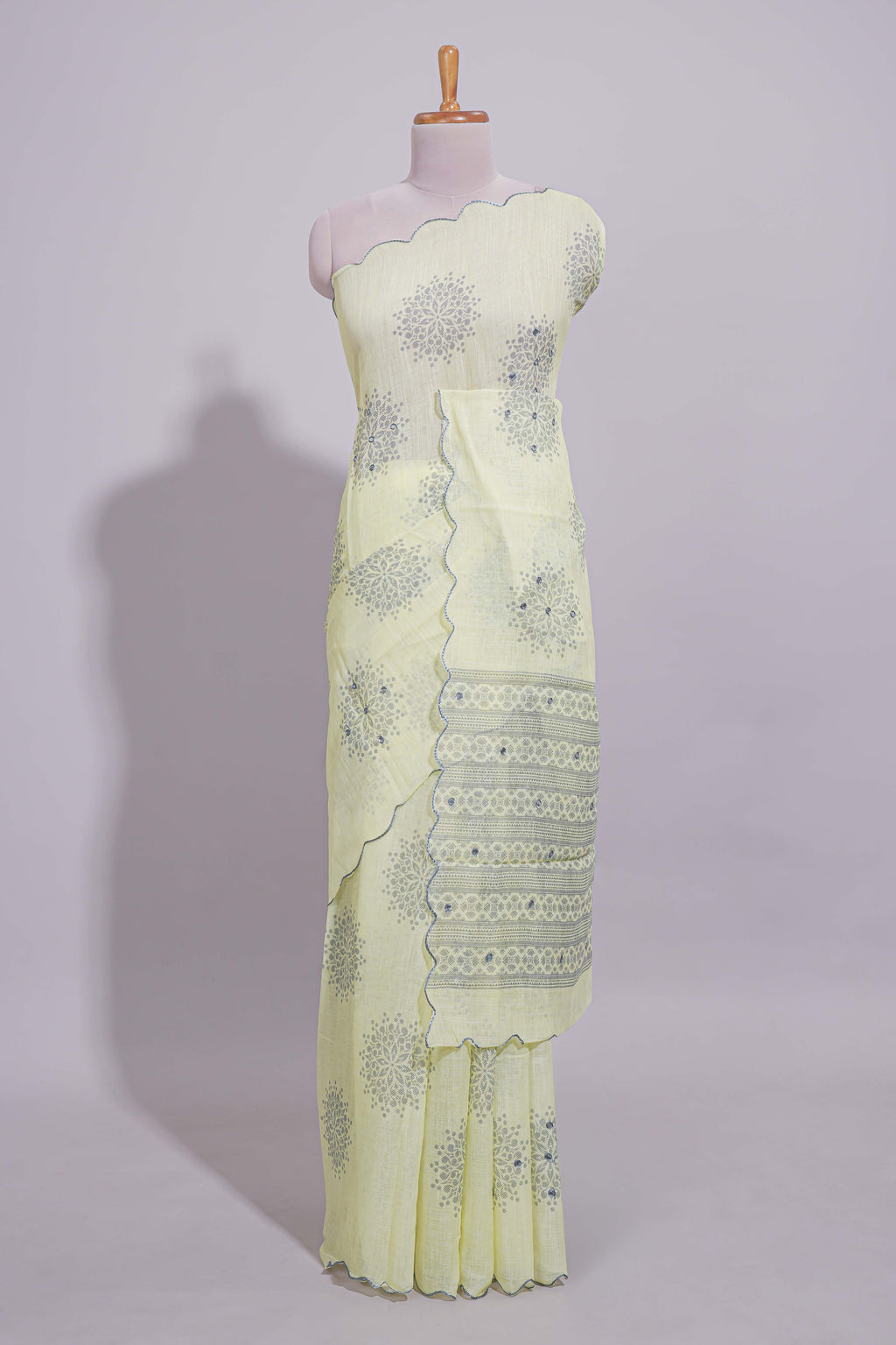 Pastel yellow linen saree tree motifs and tiny sequin with scalloped border and matching blouse
