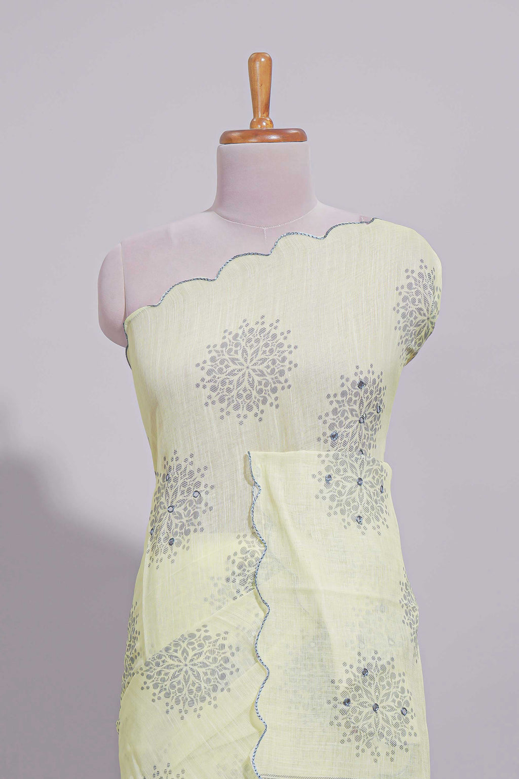 Pastel yellow linen saree tree motifs and tiny sequin with scalloped border and matching blouse
