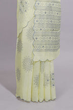 Pastel yellow linen saree tree motifs and tiny sequin with scalloped border and matching blouse