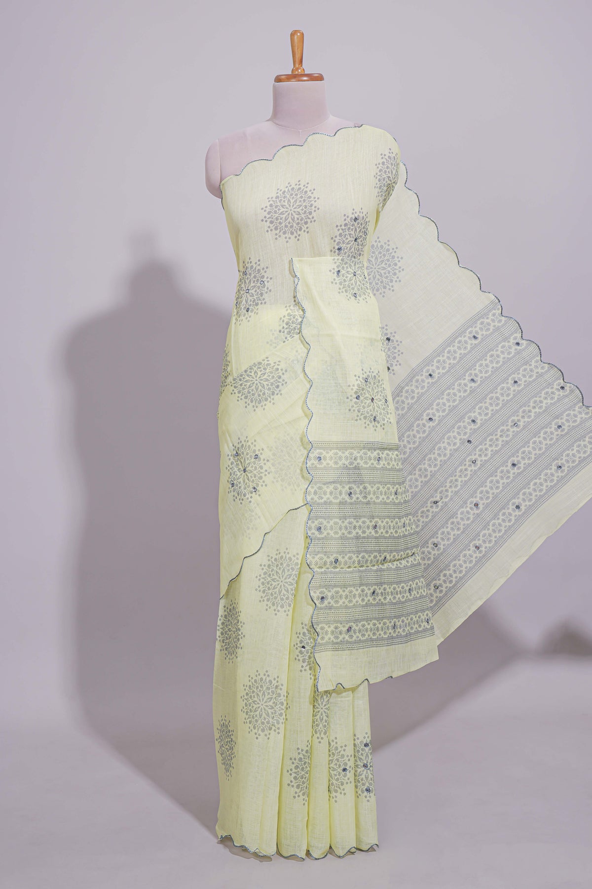 Pastel yellow linen saree tree motifs and tiny sequin with scalloped border and matching blouse