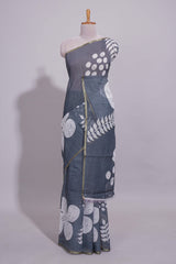 Charcoal grey linen saree with bold white floral and geometric prints finished with a subtle metallic border along with matching blouse