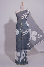 Charcoal grey linen saree with bold white floral and geometric prints finished with a subtle metallic border along with matching blouse