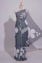 Charcoal grey linen saree with bold white floral and geometric prints finished with a subtle metallic border along with matching blouse