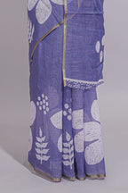 Tropical indigo linen saree with bold white floral and geometric prints finished with a subtle metallic border along with matching blouse
