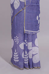 Tropical indigo linen saree with bold white floral and geometric prints finished with a subtle metallic border along with matching blouse