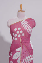 Rani pink linen saree with bold white floral and geometric prints finished with a subtle metallic border along with matching blouse