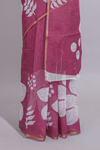 Rani pink linen saree with bold white floral and geometric prints finished with a subtle metallic border along with matching blouse
