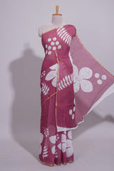 Rani pink linen saree with bold white floral and geometric prints finished with a subtle metallic border along with matching blouse