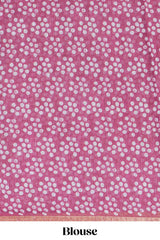 Rani pink linen saree with bold white floral and geometric prints finished with a subtle metallic border along with matching blouse