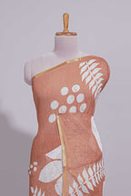 Brown linen saree with bold white floral and geometric prints finished with a subtle metallic border along with matching blouse