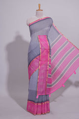 Checked linen saree with contrast border and pallu along with contrast printed blouse
