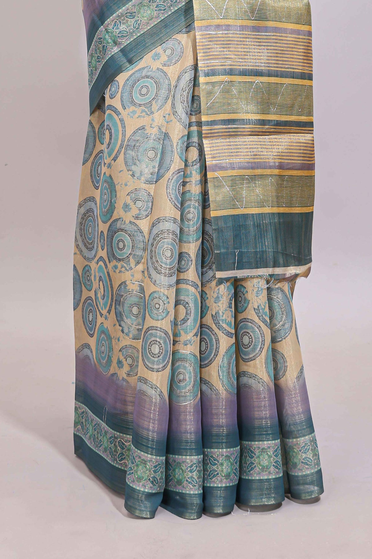 Beige colour linen cotton saree with geometric design body and contrast sea green border with geometric pallu along with matching blouse