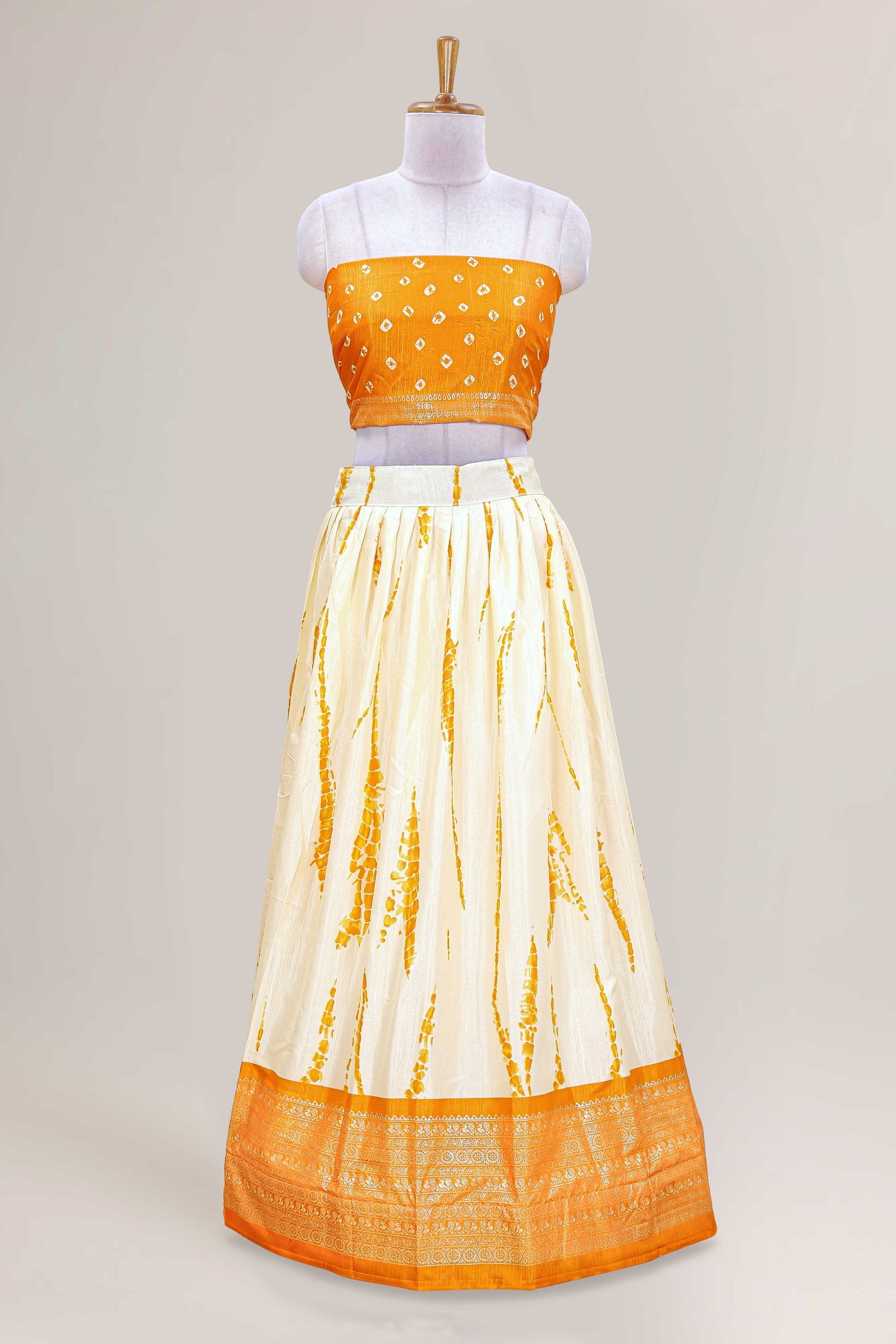 Cream dola silk bandhani designer lehenga with contrast blouse and dhavani