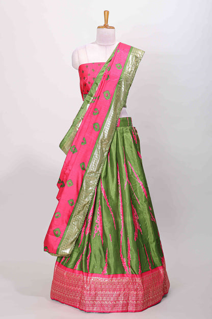Green dola silk bandhani designer lehenga with contrast blouse and dhavani