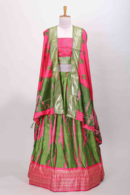 Green dola silk bandhani designer lehenga with contrast blouse and dhavani