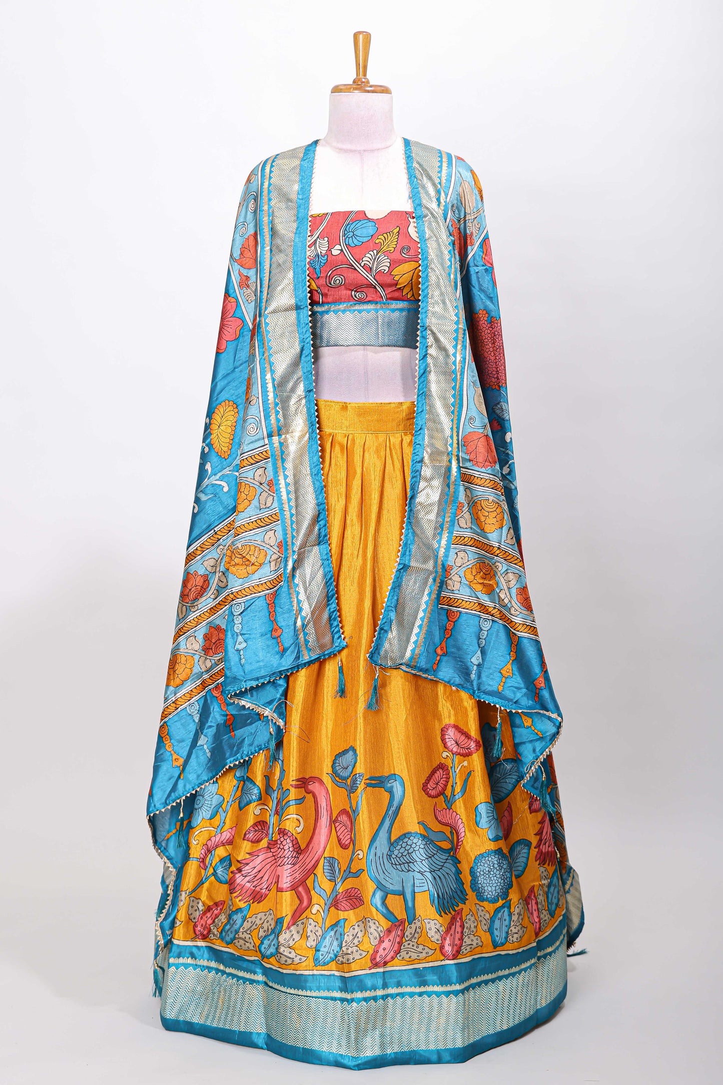 Mustard dola silk birds and floral printed lehenga with contrast blouse and dhavani