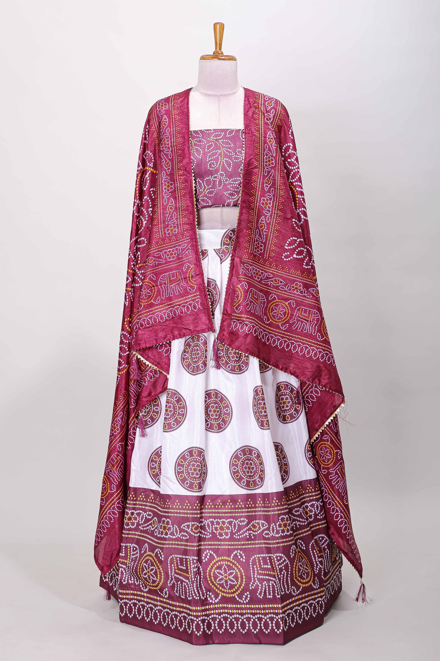 Maroon dola silk bhandani elephant and floral printed lehenga with contrast blouse and dhavani