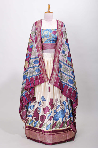 Cream dola silk birds and floral printed lehenga with contrast blouse and dhavani