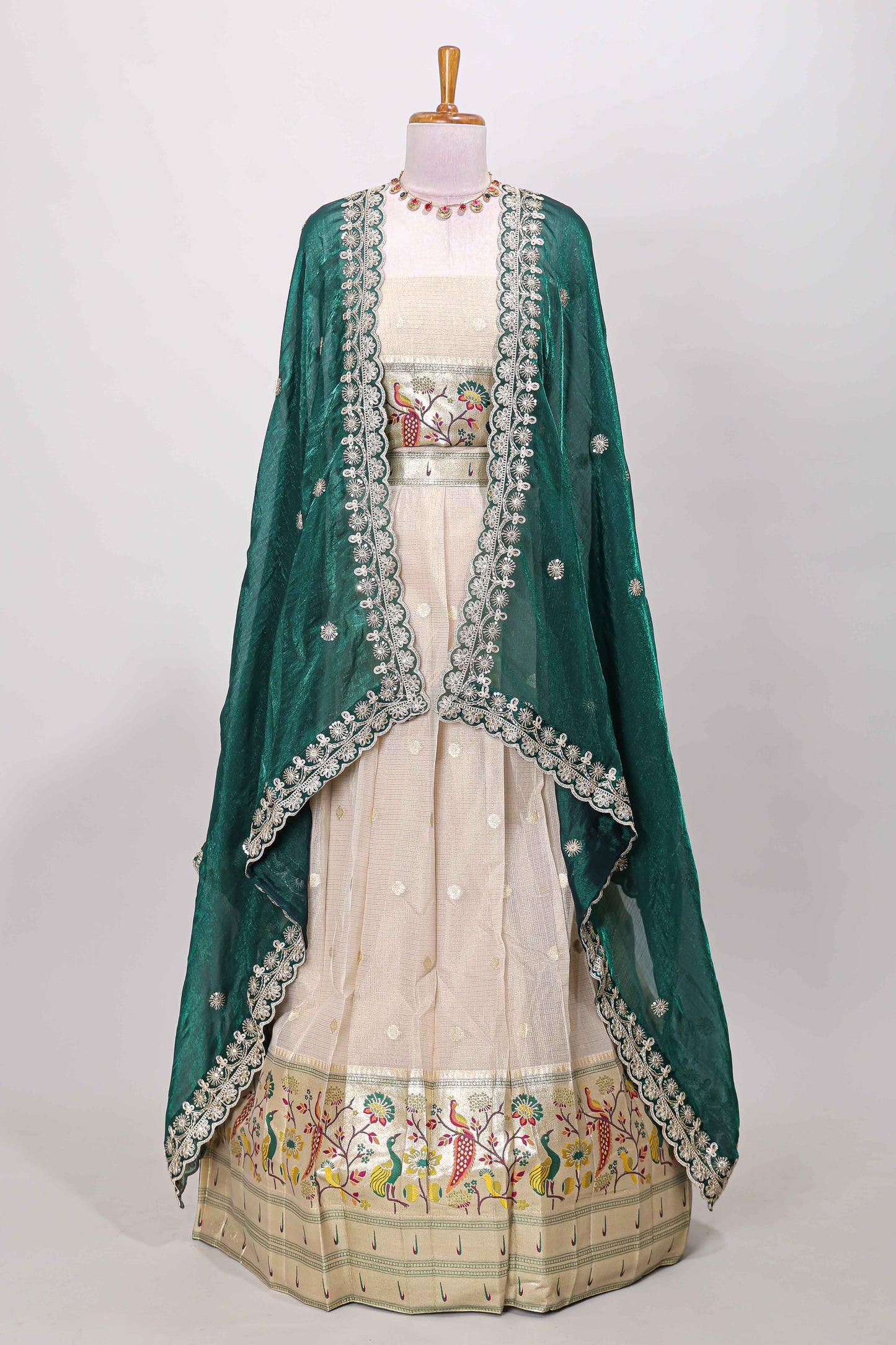 Cream cotton lehenga with floral vines zari butta design and green border dhavani