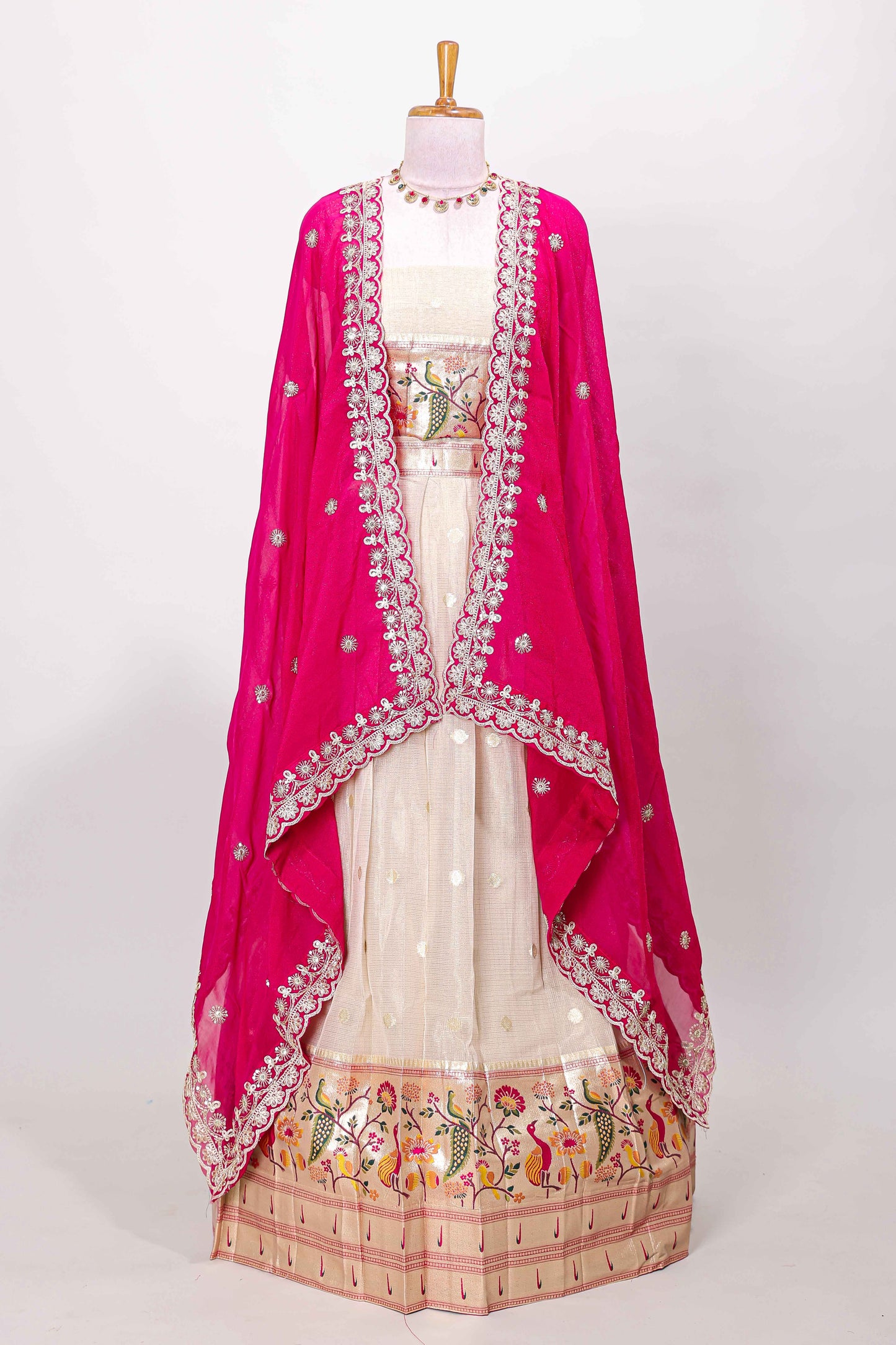 Cream cotton lehenga with floral vines zari butta design and pink border dhavani