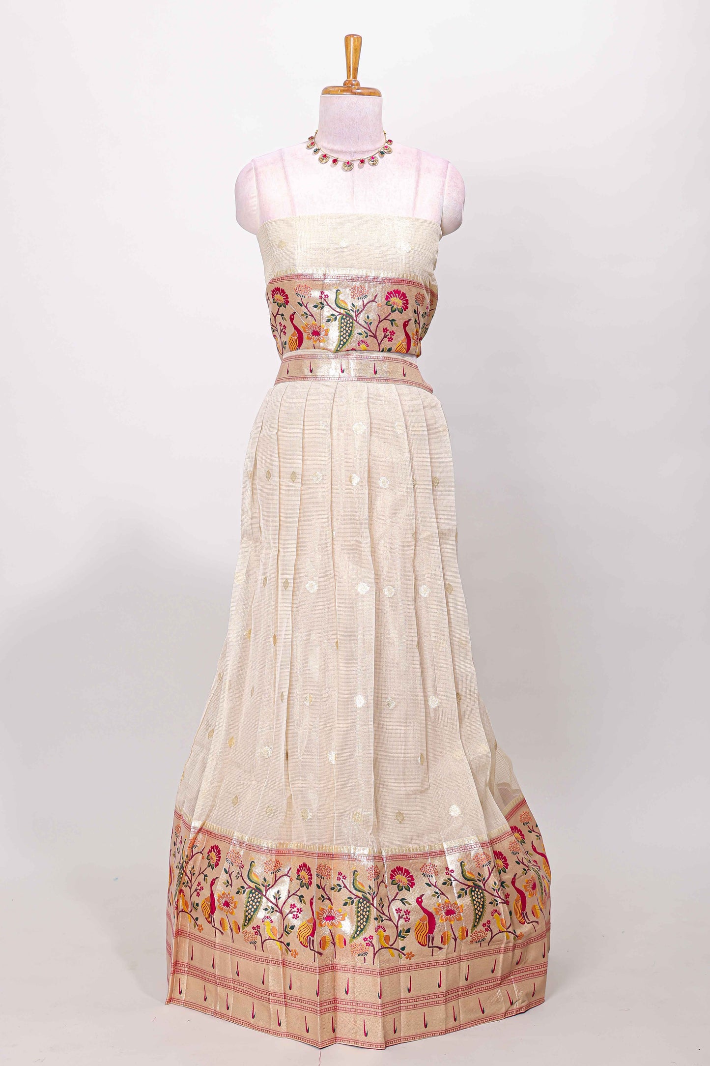 Cream cotton lehenga with floral vines zari butta design and pink border dhavani
