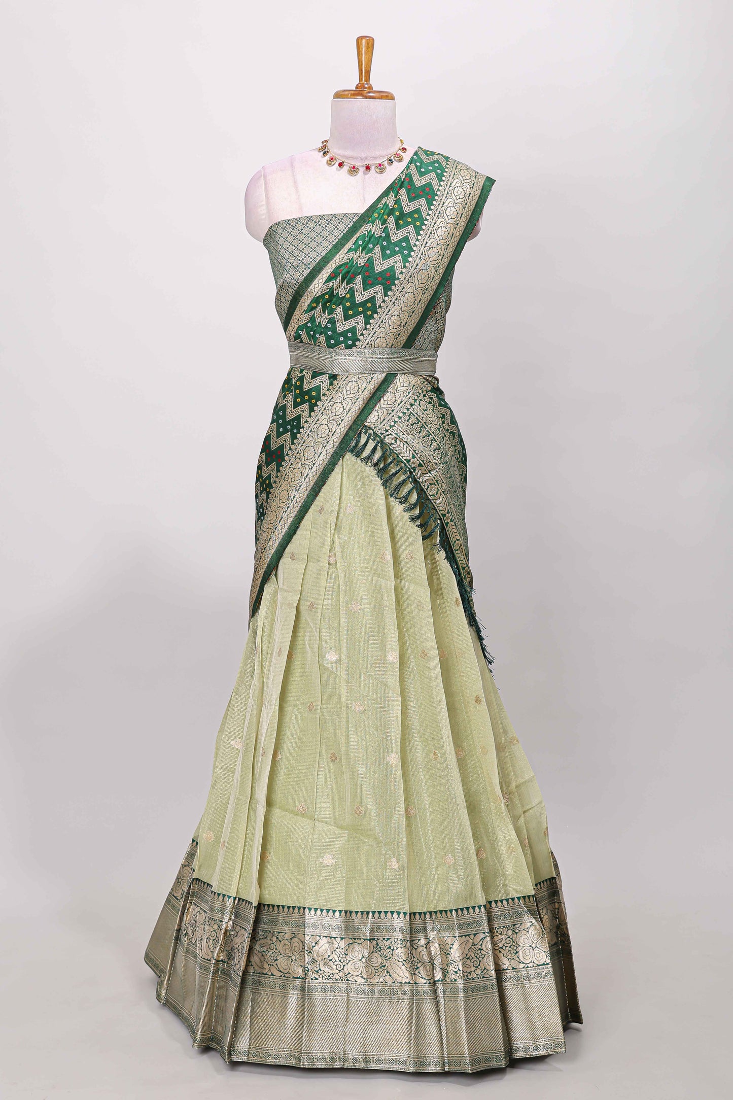 Green kota cotton lehenga featuring a textured body with zari butta, finished with a contrast border and matching dhavani