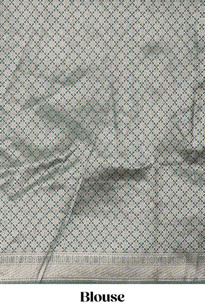 Green kota cotton lehenga featuring a textured body with zari butta, finished with a contrast border and matching dhavani