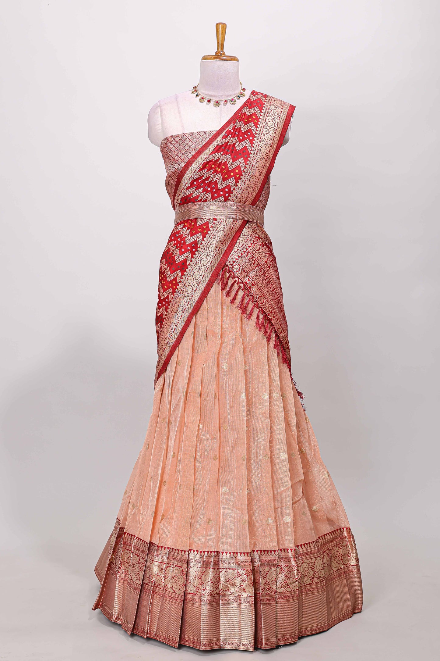 Orange kota cotton lehenga featuring a textured body with zari butta, finished with a contrast border and matching dhavani